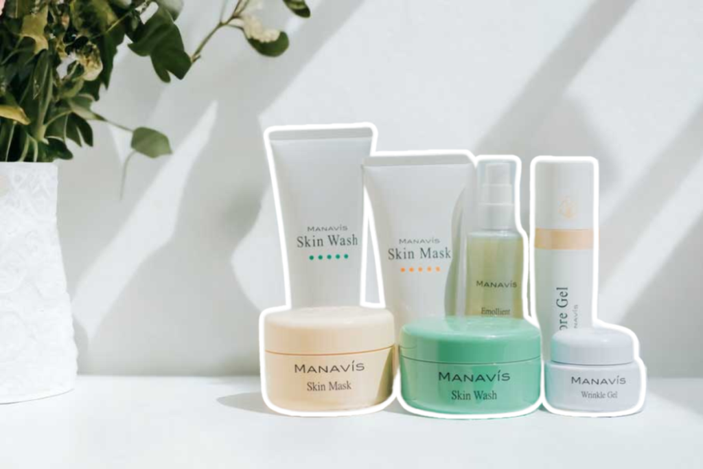 A bottle of Manavis skincare product, featuring plant-derived ingredients and olive oil, promising radiant and healthy skin.