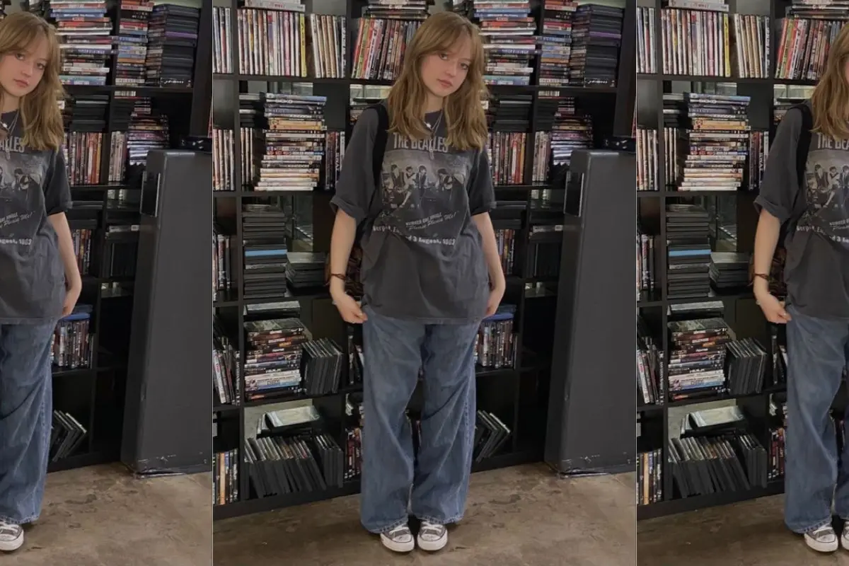 Girl standing in a music archive in Grunge Aesthetic Attire.