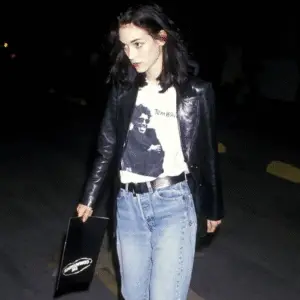 Winona Ryder in edgy 90s grunge fashion – band tee, leather jacket, and bold makeup