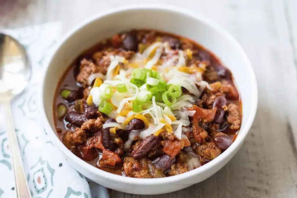 Spicy beef chili topped with herbs, cooked quickly – family-friendly Gluten Free Instant Pot Recipes.