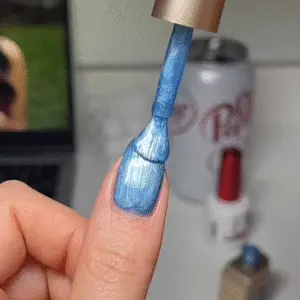 Adding a second coat of cat eye nail polish and using the magnet again to deepen the glowing cat eye nails effect.