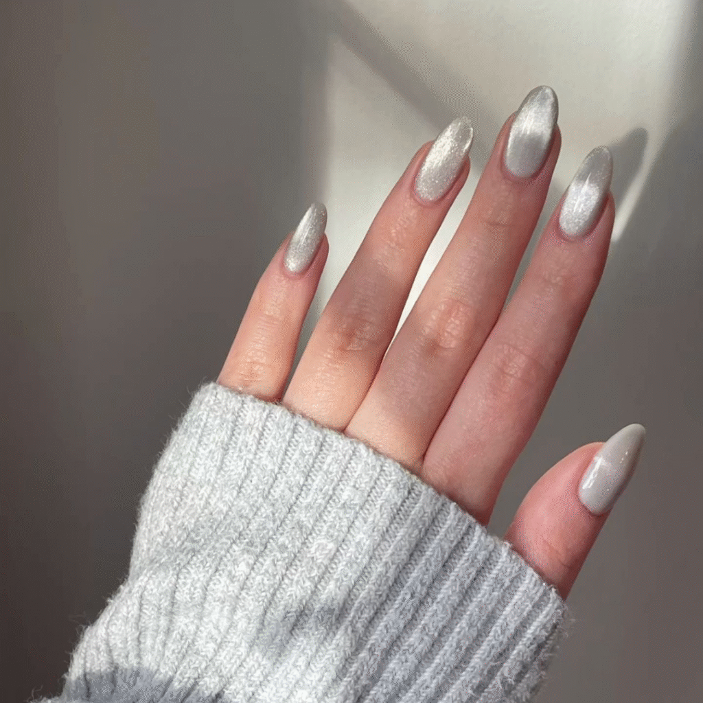 Long white cat eye nails with a glassy, reflective finish for a modern, chic look.