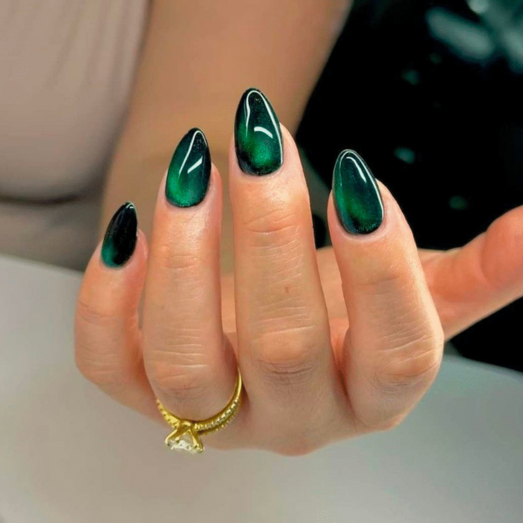 Short green cat eye nails with a glossy metallic hue and smooth finish.