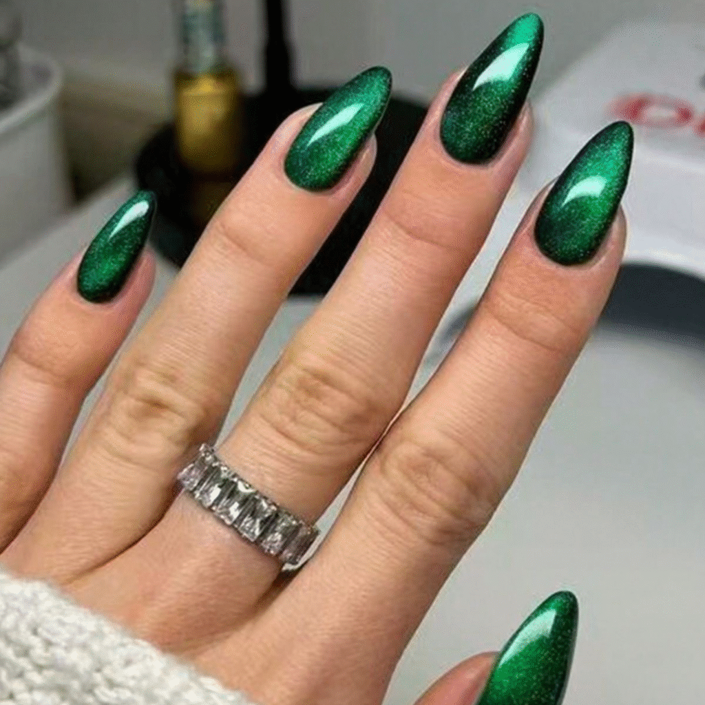 Long green cat eye nails with an emerald glow and high-shine magnetic finish.